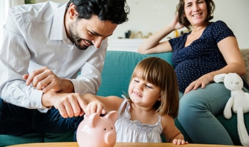 Family Saving Money in Piggy Bank — Financial Advisors in Maroochydore, QLD