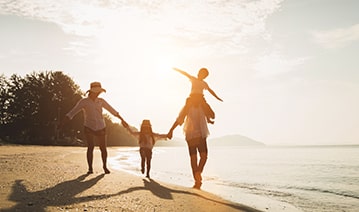 Happy Family Travel on Beach in Holiday — Financial Advisors in Maroochydore, QLD